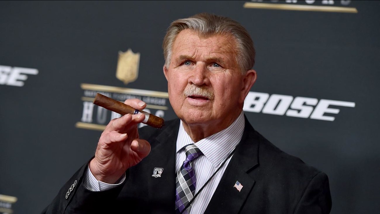 Mike Ditka holding a cigar at an NFL event