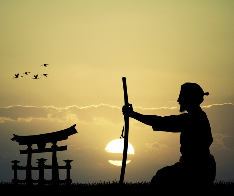 Samurai silhouette at sunset with torii gate