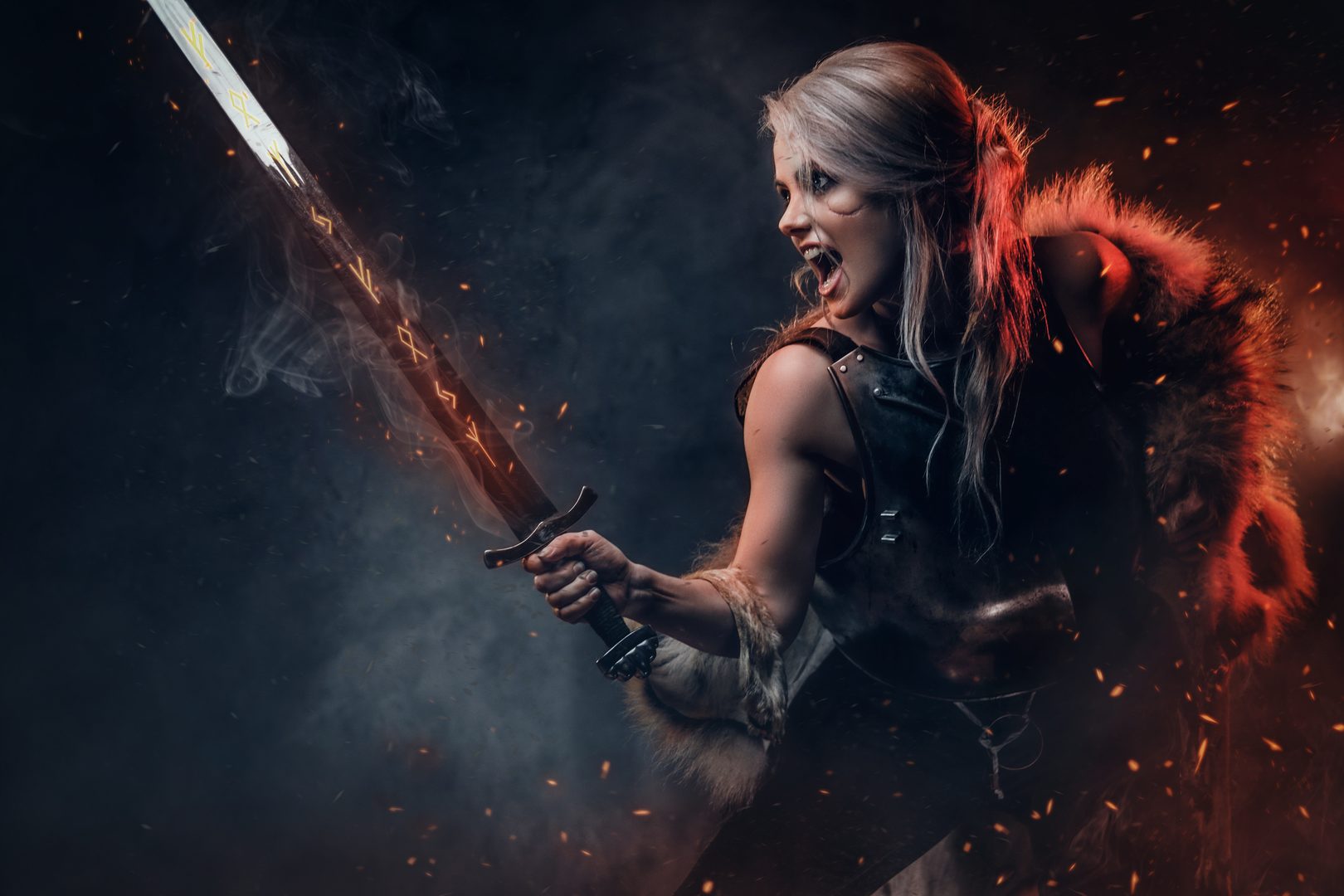 A warrior woman in fantasy armor with a glowing sword against a fiery background